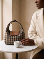 The Houndstooth Deauville on a marble cafe table