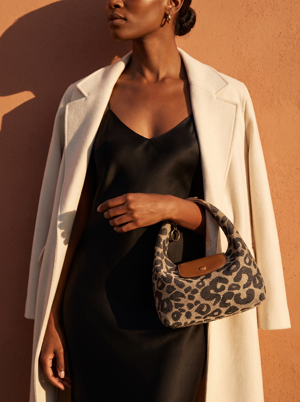 Model holding the Leopard Deauville in hand at golden hour