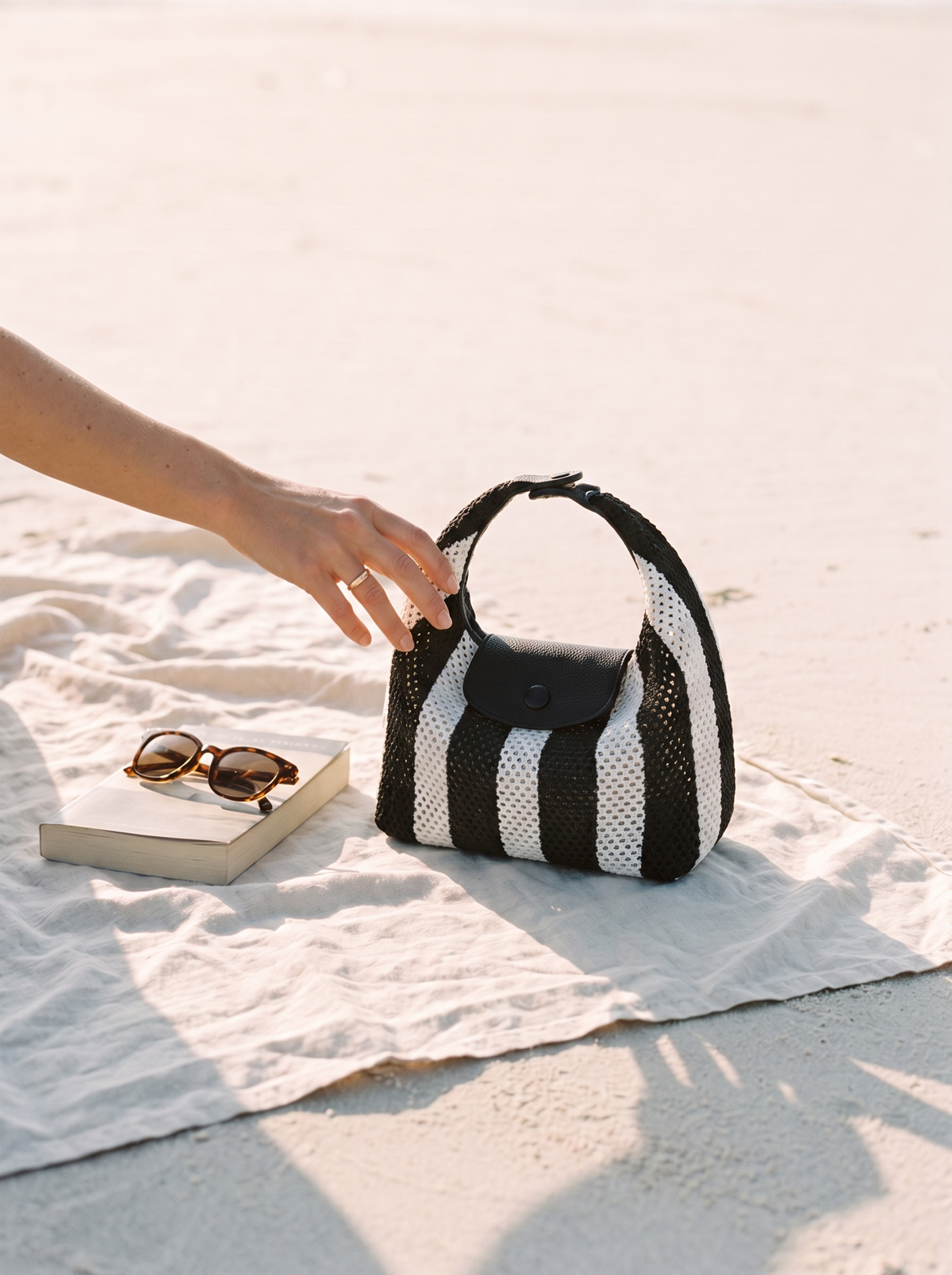 The Deauville in Stripe Noir, open on a beach towel
