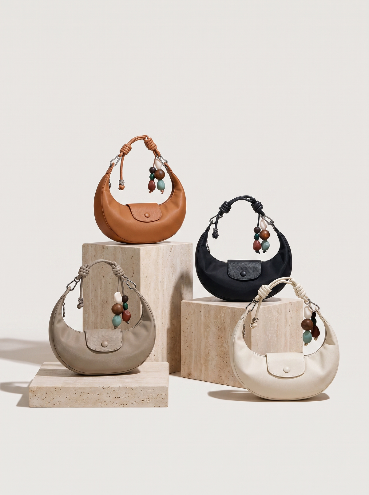 The Demilune in Taupe, Caramel, Noir and Ivory, side by side