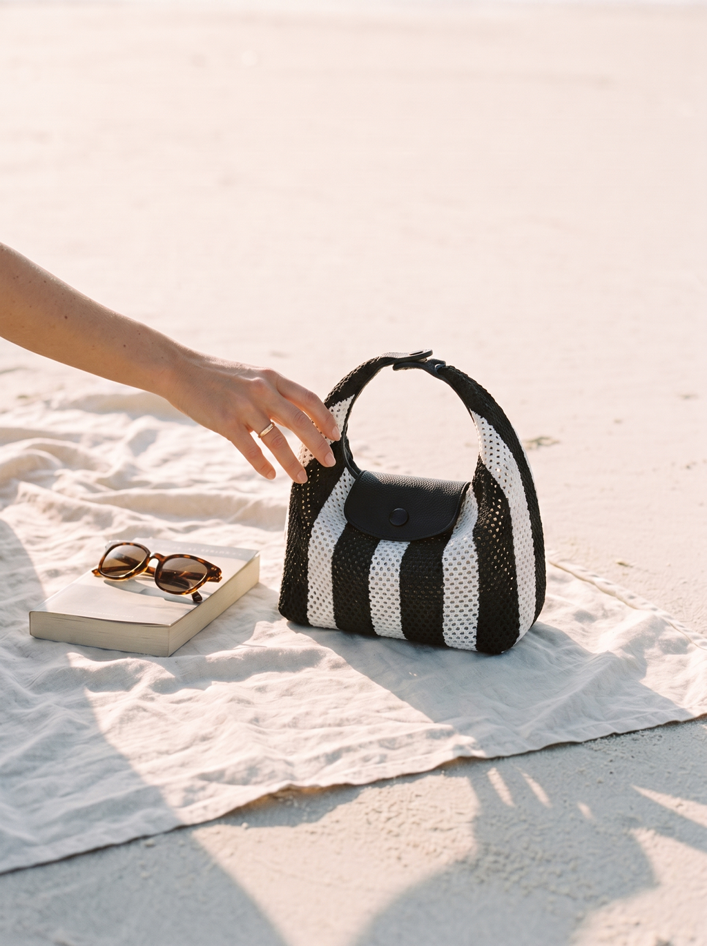 The Deauville in Stripe Noir, open on a beach towel
