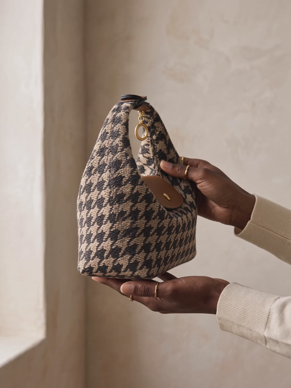 The Deauville in Houndstooth, turned to the light in the hands