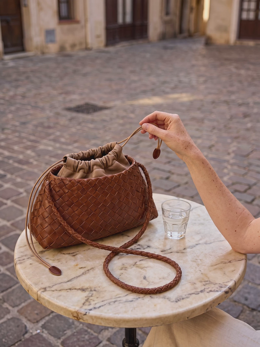 The Antibes in Cognac on a cafe table, drawstring loosened, eight second film